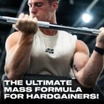 Athlete performing a bicep curl in the gym wearing a MuscleTech shirt, representing the power and intensity behind MuscleTech Mass-Tech Extreme — the ultimate mass gainer formula designed for hardgainers to build muscle size, strength, and performance.
